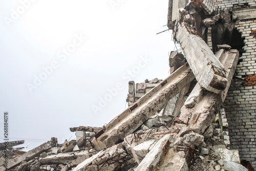 A huge pile of gray concrete debris from piles and stones of the destroyed building. Copy space.