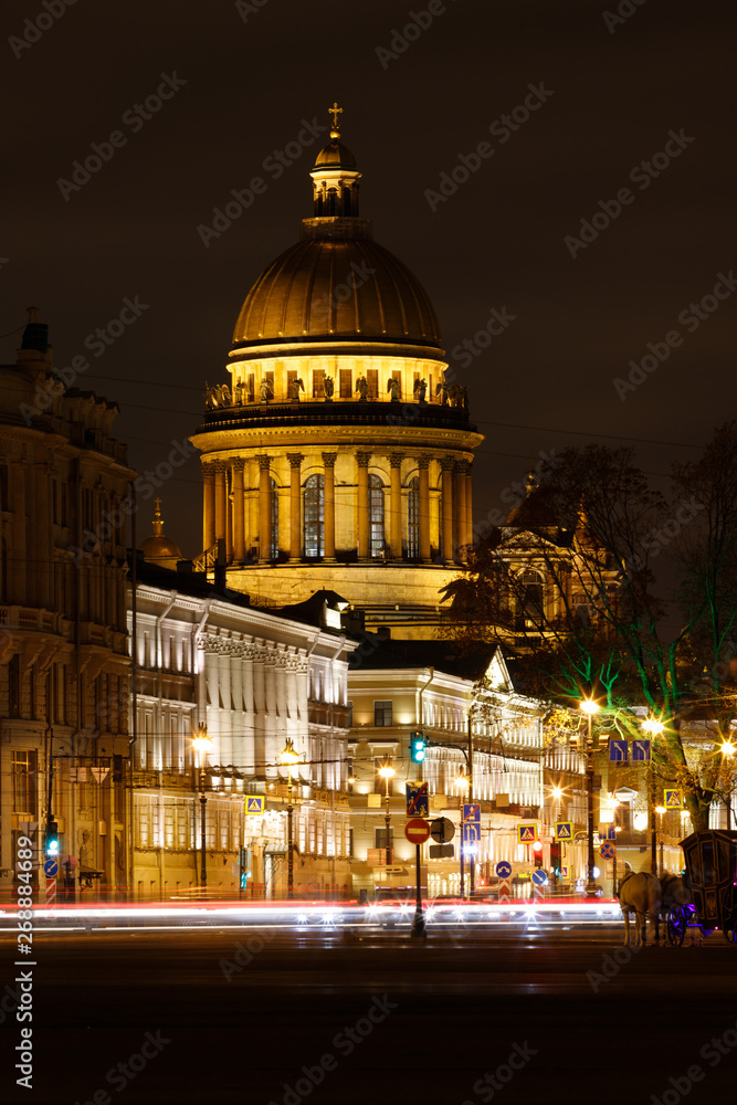 Saint Isaacs Cathedral by night illuminated by street lights as seen from Palace Square next to Eremitage during winter (St. Petersburg, Russia, Europe)