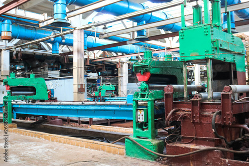 Beautiful metal industrial powerful equipment of the production line on machine-building oil refining, petrochemical, chemical plant, conveyor belt with machine tools.