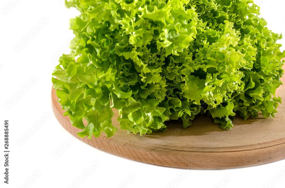 bunch of green lettuce on wooden board isolated on white background. Salad leaves.