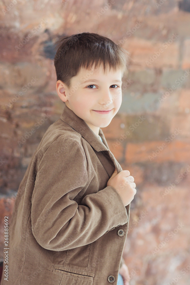 teen young boy posing at studio over brick wall background teen young boy posing at studio over brick wall background