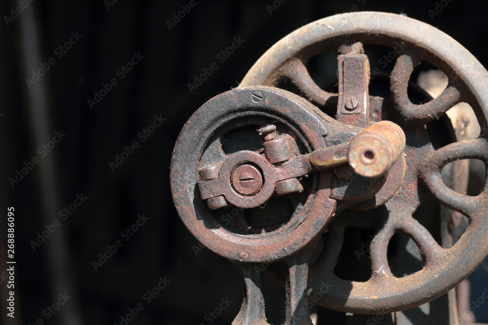 Old sewing machine, with manual drive. Covered with corrosion, dust and cobwebs. Old sewing machine, with manual drive. Covered with corrosion, dust and cobwebs.