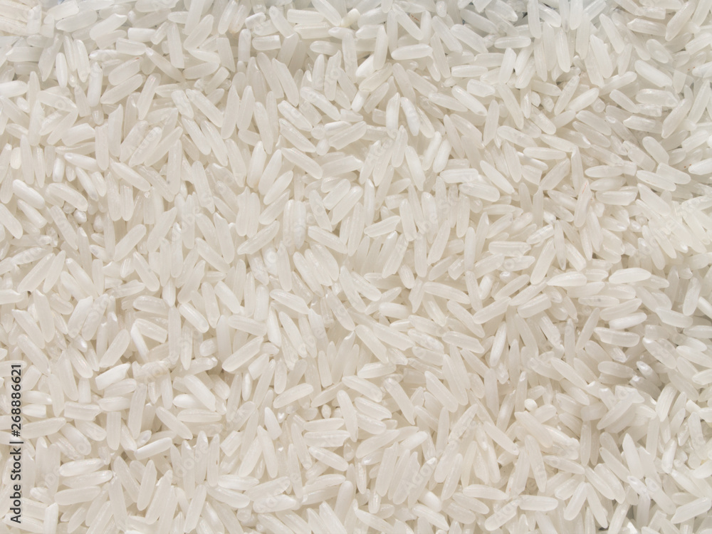 the background is of a dry cleaned white raw milled rice scattered on the plate the background is of a dry cleaned white raw milled rice scattered on the plate