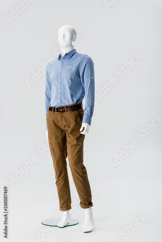 white plastic mannequin in clothes isolated on grey