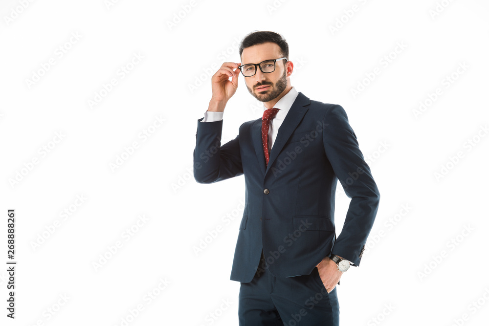 confident businessman touching glasses and looking at camera isolated on white confident businessman touching glasses and looking at camera isolated on white