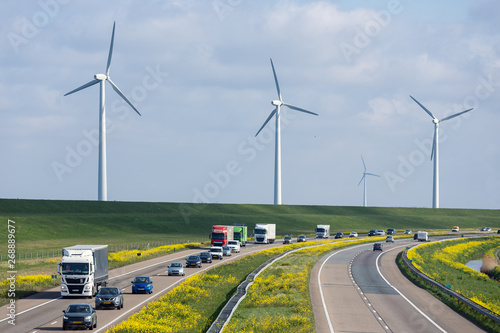 Dutch motorway near Lelystad with wind turbines and blooming rapeseed photo