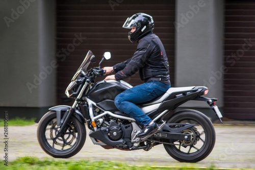 biker rides a motorcycle in the city