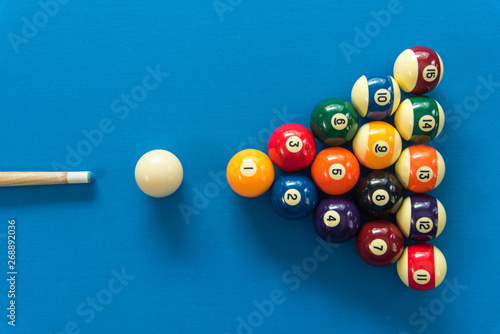 pool or billiards balls on light blue table photo