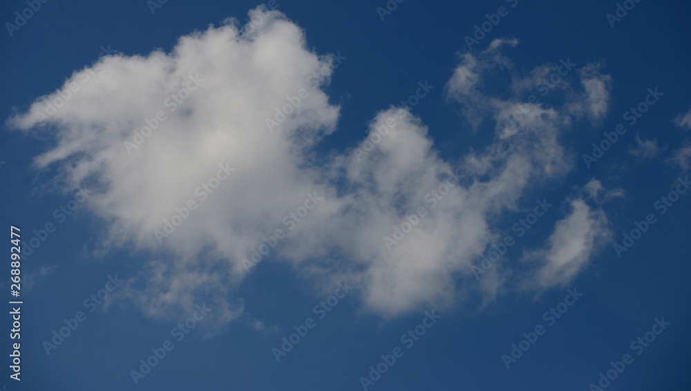 Cottony clouds, cumulus clouds, in a blue sky
