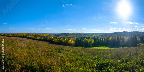 Panoramic view of trees of the autumn wood from above, with blue sky, Stone Hill, Mari El, Russia © Evgesha
