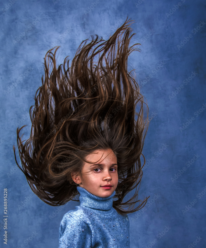 nice girl with an unusual hairstyle. Blast of hair. Stock Photo | Adobe Stock nice girl with an unusual hairstyle. Blast of hair. Stock Photo | Adobe Stock