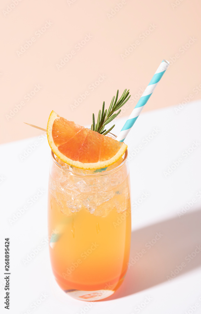 Cold and refreshing orange punch cocktail with orange slice on color background. summer drink. Cold and refreshing orange punch cocktail with orange slice on color background. summer drink.