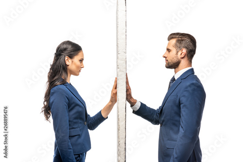businessman and businesswoman in suits separated by wall isolated on white