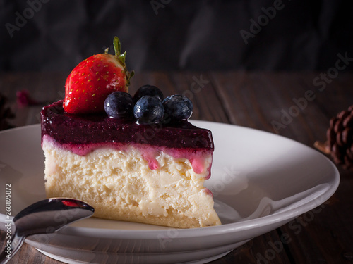 Blueberry cheesecake decorate with pinecorn and dry flower on wood board photo