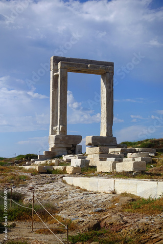 Iconic and unique Temple of Apollon or Portara (Gate) with breathtaking views to port - town and castle of Naxos island and the Aegean blue sea, Cyclades, Greece