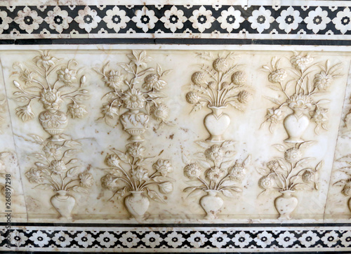 Part of the marble wall with carving in the form of vases with flowers in one of the halls of the ancient palace Shish Mahal, 17th century, in the old Amber Fort, Jaipur, India