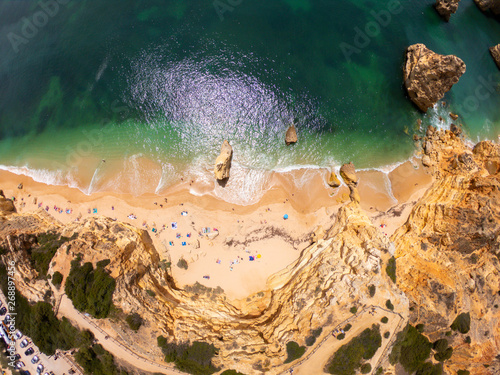 Top view on coast of Atlantic Ocean, beach and cliffs in Praia de Marinha, Algarve Portugal