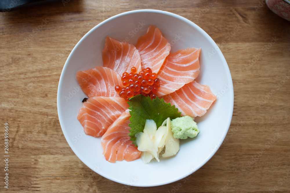 salmon sashimi put into white bowl salmon sashimi put into white bowl