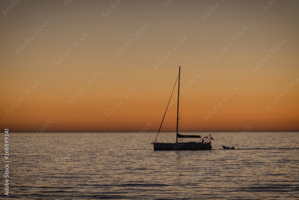 Sunset behind adriatic sea with boat, Slovenia Sunset behind adriatic sea with boat, Slovenia