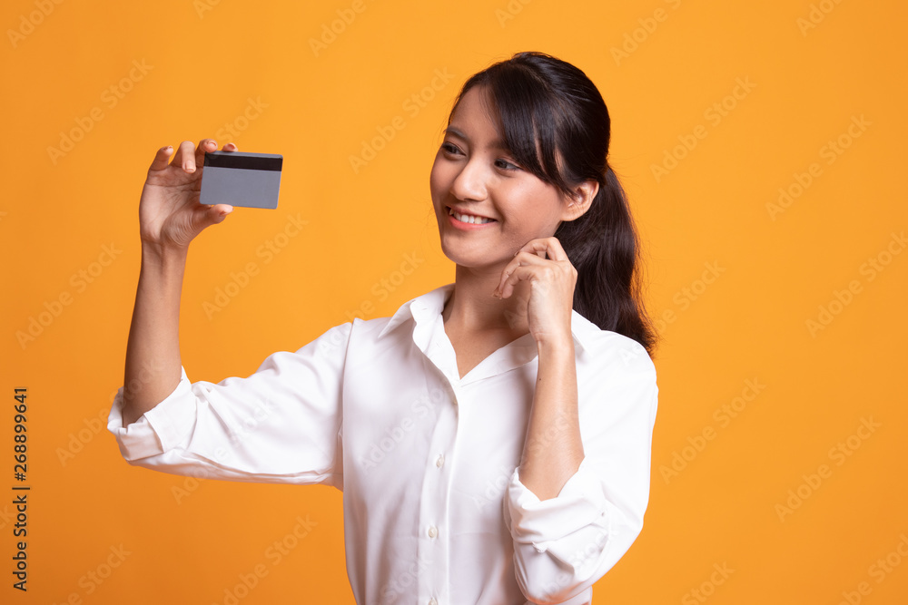 Happy young Asian woman with a blank card.