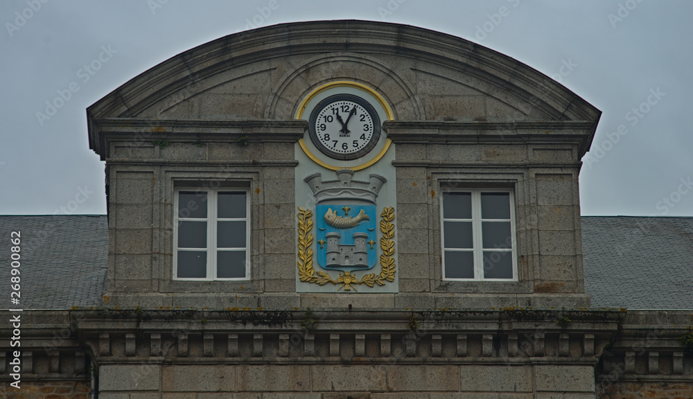 Domed building top with clock and coat of arms at Avranches, France