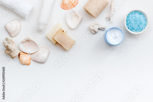 cosmetics with Dead Sea minerals and shells on white background top view copy space