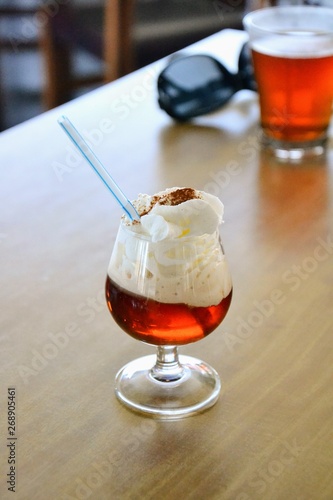The rum and honey mixture (called Ron miel) served with whipped cream and cinnamon in a glass. Lanzarote special traditional drink, Canary Island, Spain 