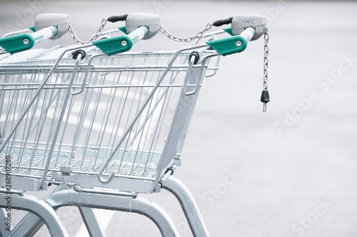 Trolley with coin operated lock chain in supermarket car park photo