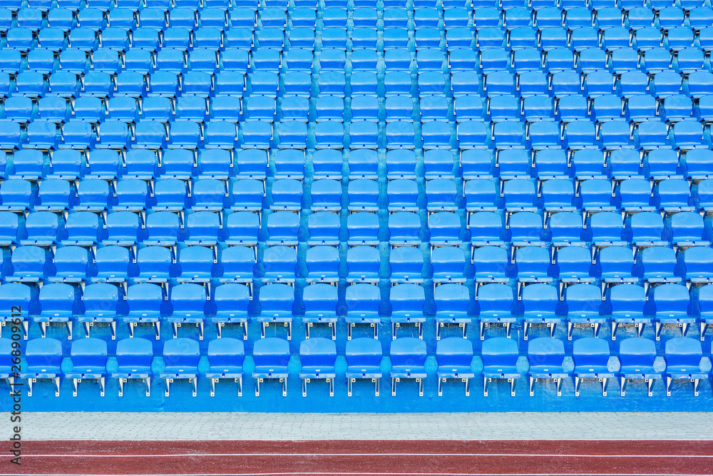 Fototapeta premium Blue empty seats on the tribune of the new stadium.