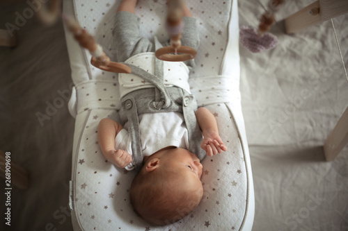 newborn baby sleeps in special mattress device