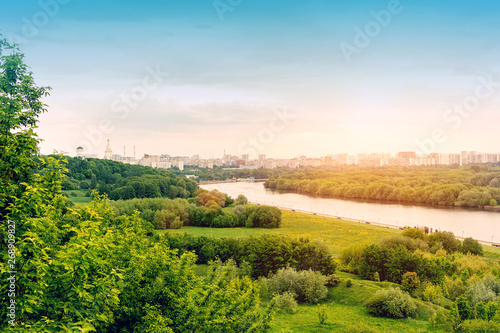 Amazing spring cityscape, green background, city river, Moscow.