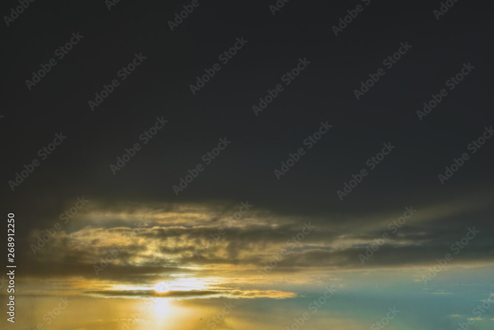 The sky with dark clouds illuminated by the setting sun The sky with dark clouds illuminated by the setting sun