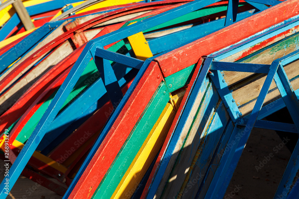 Colorful beach benches stacked in a pile, close-up. Abstract background, geometry