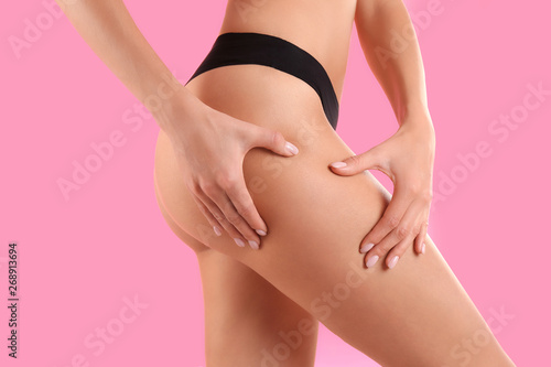 Closeup view of slim woman in underwear on color background. Cellulite problem concept © New Africa