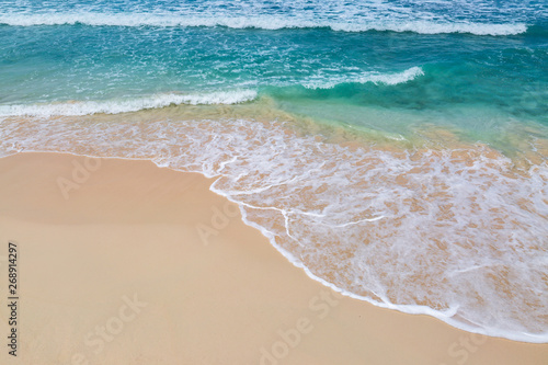 The turquoise sea lapping a sandy beach, on the Caribbean island of Barbados