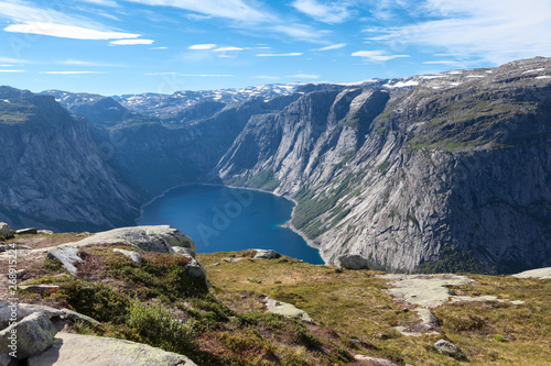 Norwegian landscape with mountains and lake. Picturesque view from pathway to Trolltunga attraction. Norway, Scandinavia