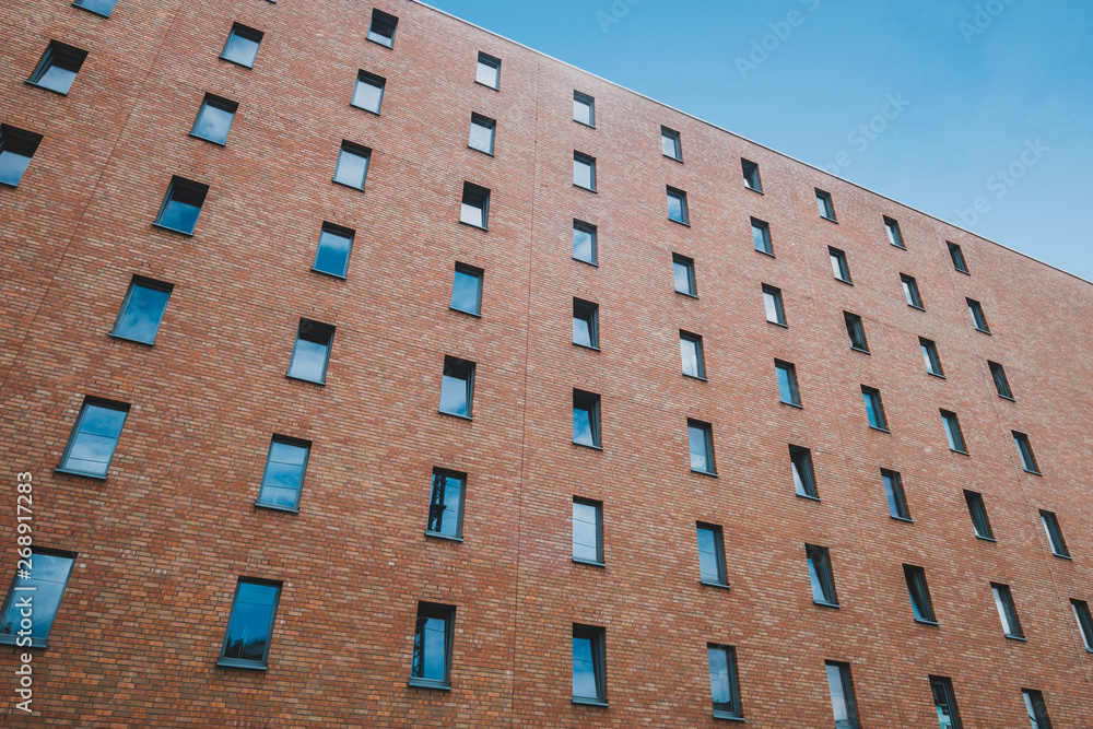 windows on brick building facade of apartment block