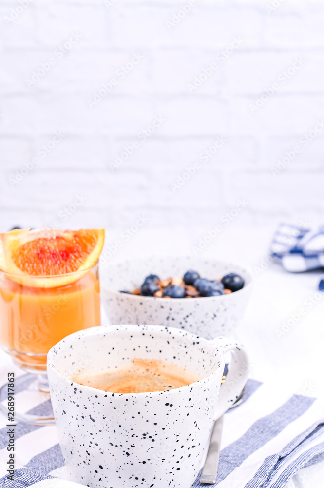 Traditional european breakfast on white wooden background. Muesli with berries and orange juice. Traditional european breakfast on white wooden background. Muesli with berries and orange juice.