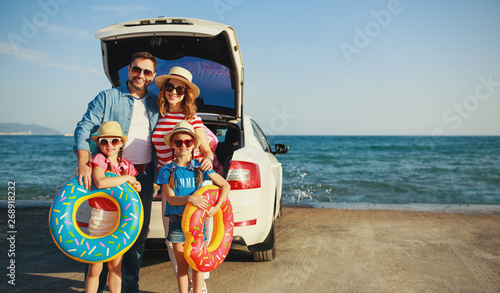 happy   family  in summer auto journey travel by car on beach.