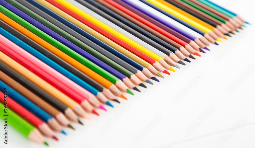 colored pencils lying in row colored pencils lying in row
