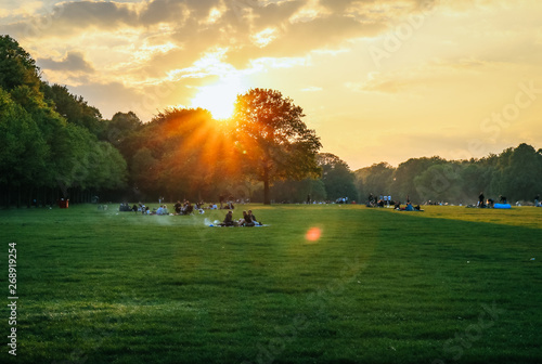 Fototapeta Naklejka Na Ścianę i Meble -  Beautiful Sunset and people grilling and having a picnic at the Stadtpark in Hamburg, Germany.