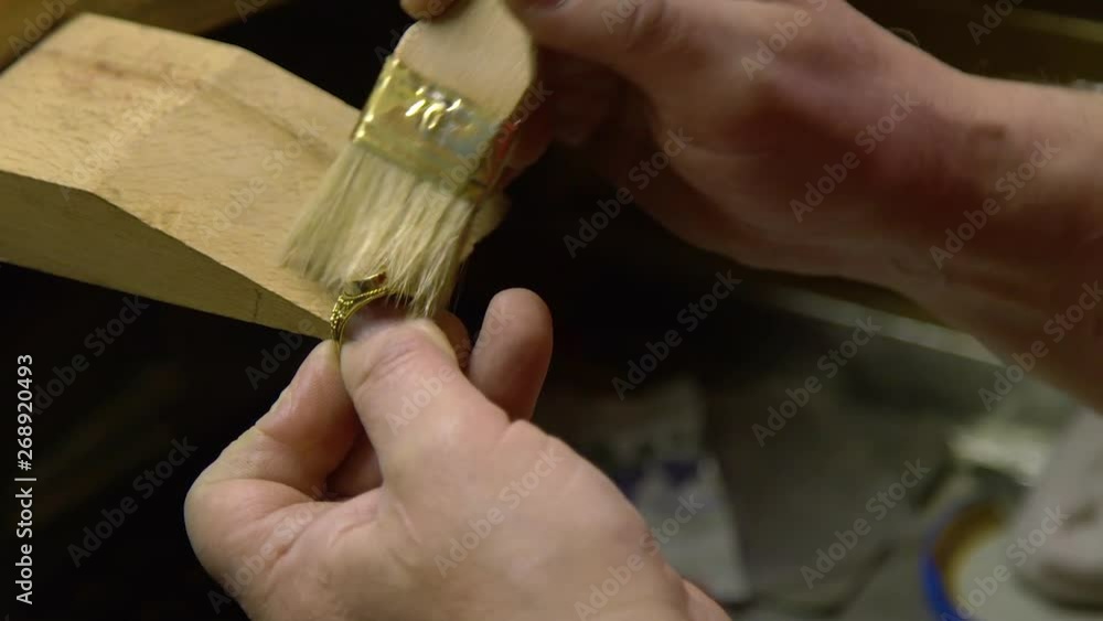 Jeweler in the workshop engraves the ring Jeweler in the workshop engraves the ring