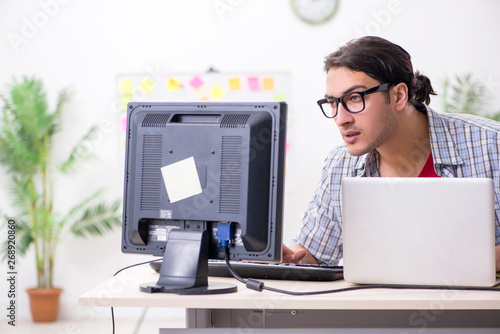 Male it specialist working in the office 