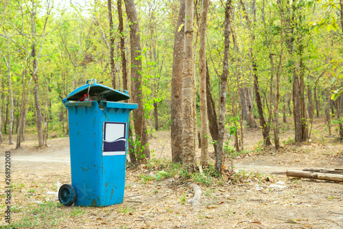 Blue trash bin in the natural park.