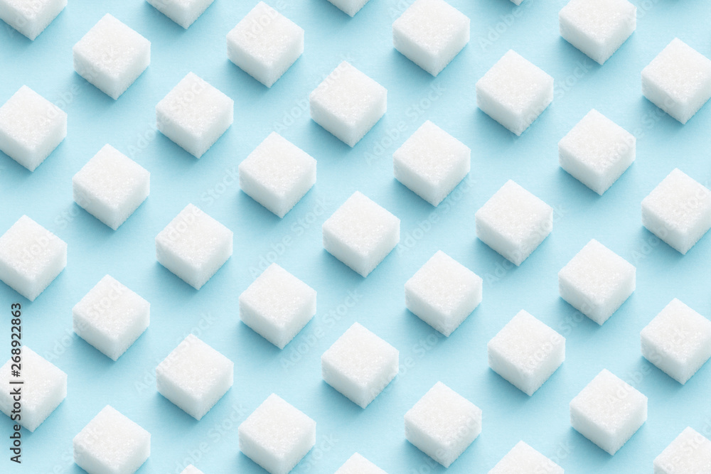 Pattern made of sugar cubes on blue abstract geometry minimal style background Pattern made of sugar cubes on blue abstract geometry minimal style background