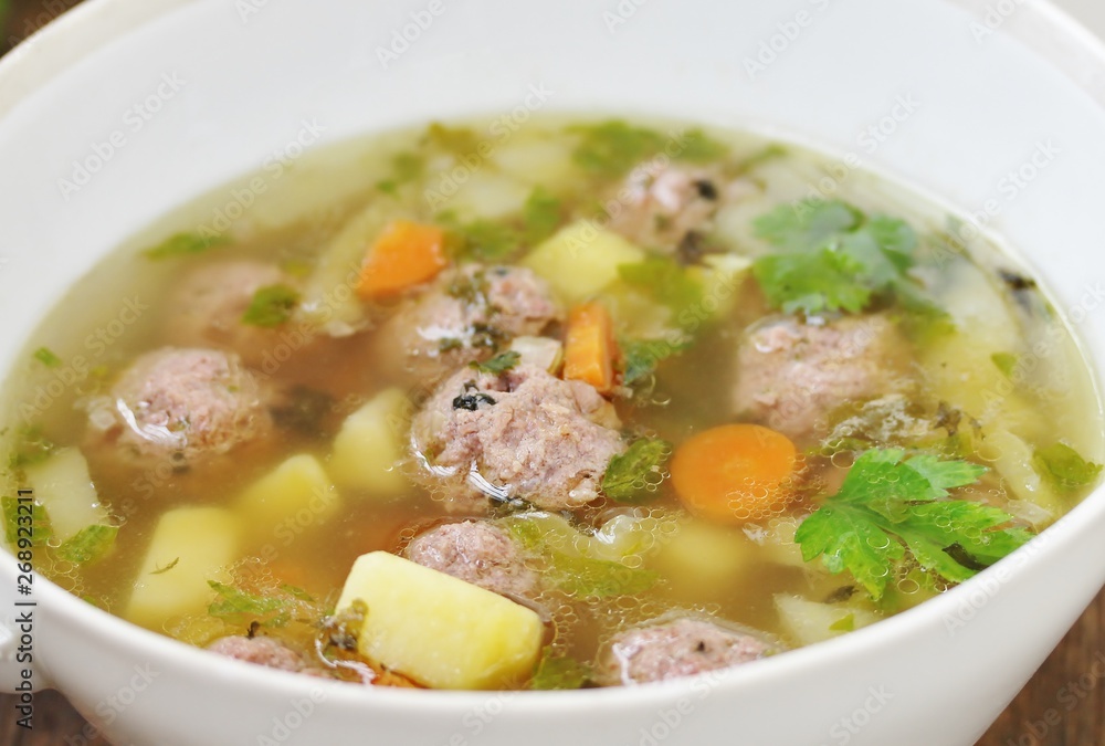 Italian Wedding Meatball Soup. soup in a beautiful white bowl