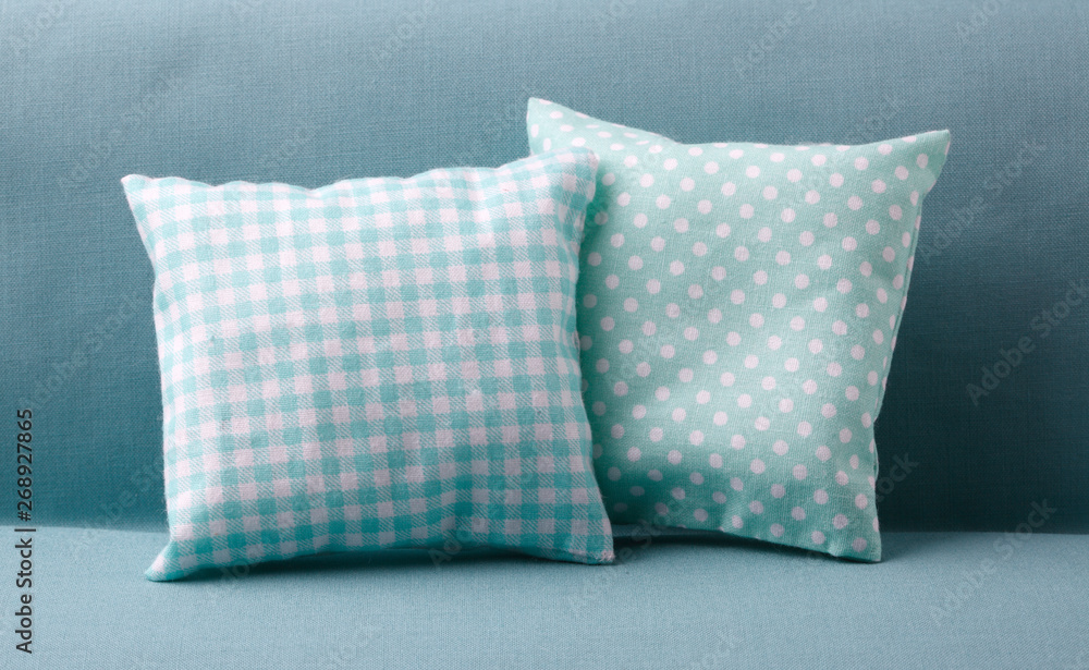Couple of turquoise pillows on the sofa Couple of turquoise pillows on the sofa