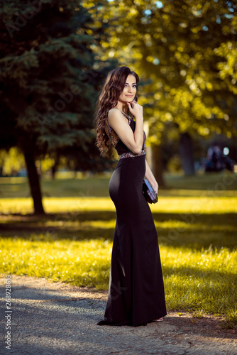 Beautiful young lady in luxury black dress is ready for her prom night