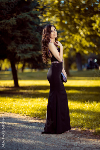 Beautiful young lady in luxury black dress is ready for her prom night