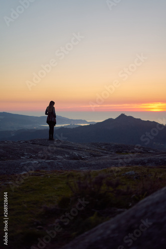 Silhouette of a woman contemplating the sunset from Mount Gali  eiro in Vigo  Galicia  Spain